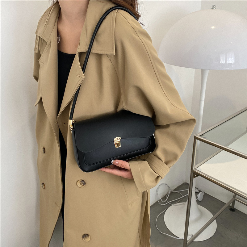 2024 otoño y invierno bolsos de mujer de moda francesa nicho bolsos de hombro de brazo irregulares bloqueo textura popular bolsos de mujer