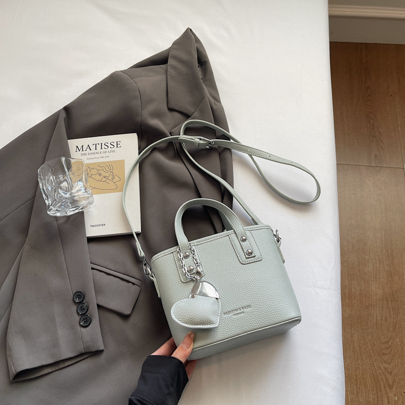 Bolso de cubo portátil transfronterizo simple y de alta gama para mujer 2025 nuevo bolso de hombro de estilo occidental de todo fósforo bolso de mensajero de moda