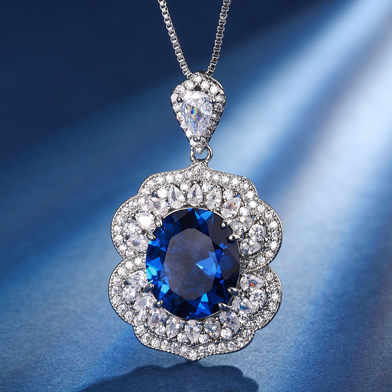 Otoño e invierno Nueva Zhuang Sheng joyería de cobre inferior chapado en oro simulación rojo corindón zafiro azul cristal puntiagudo traje avanzado femenino 12*14