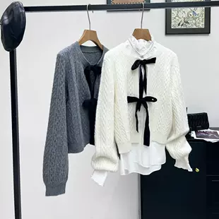 Вязаный кардиган с завязками и косами