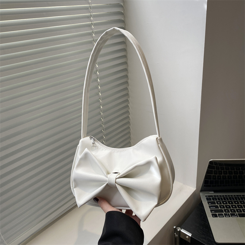 Bolso de axila con lazo de moda 2025 verano nuevo producto moda simple viajero estilo explosivo transfronterizo todo fósforo bolso femenino de un solo hombro