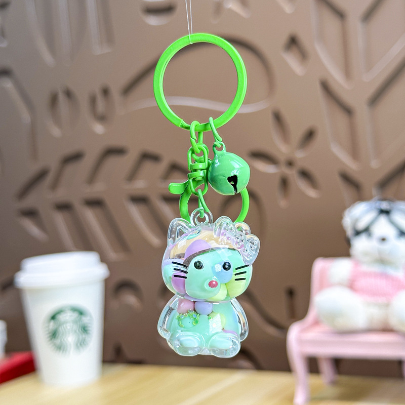 Caricatura en aceite líquido arena flotante botella mochila llavero delicado colgante accesorios accesorios máquina de muñecas pequeños regalos al por mayor