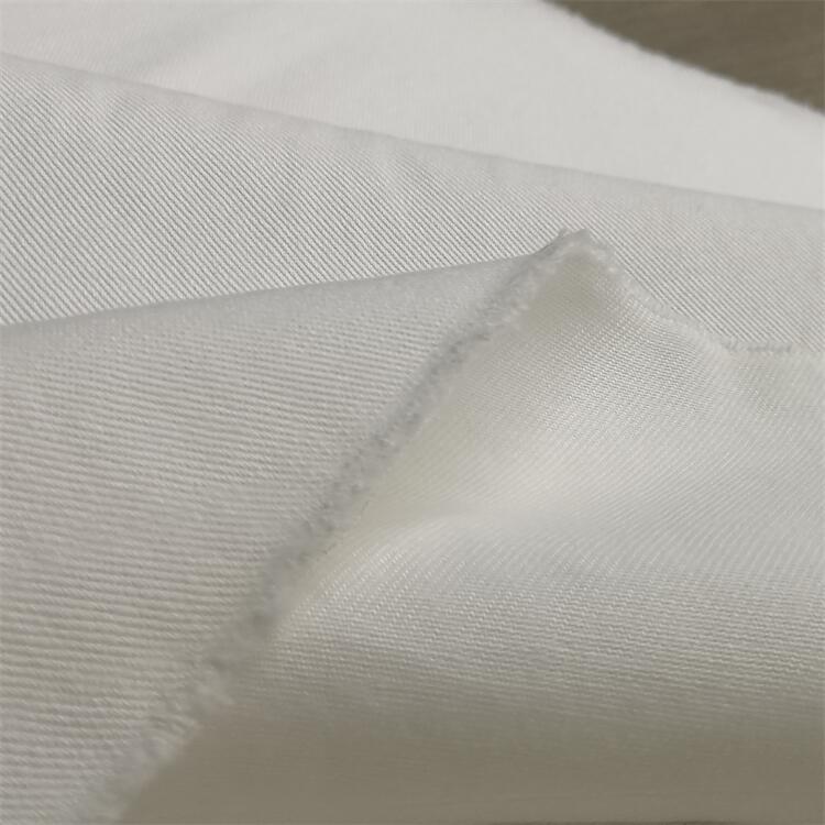 Fabricante al por mayor micro elástico tela de spandex de twill 250gsm pantalones blancos tela elástica de algodón de twill cómodo superficie de spandex