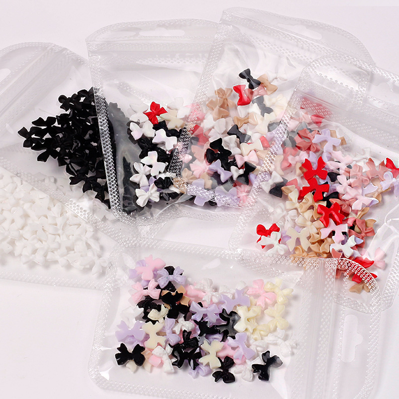 Joyas de arco de uñas al por mayor en línea explosión simple de resina joyas de uñas estereoscópicas flotantes mezcladas 50