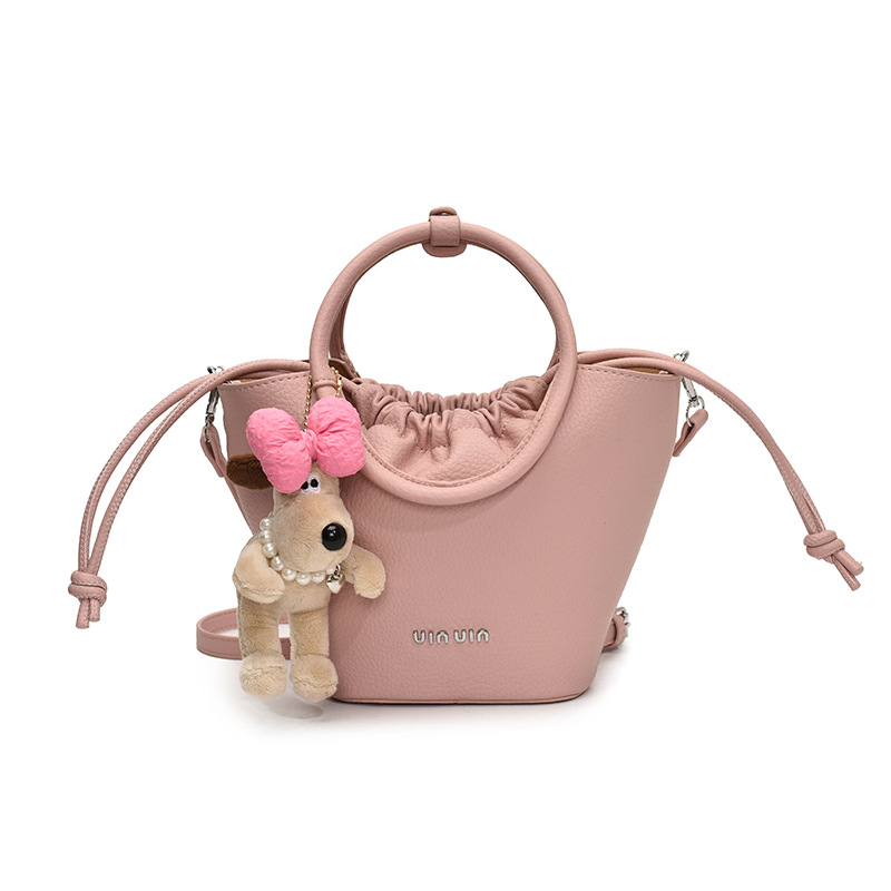 Bolsos de mano de nicho de tendencia transfronteriza para damas 2025 nuevo bolso de hombro simple de moda con textura bolso de cubo de todo fósforo