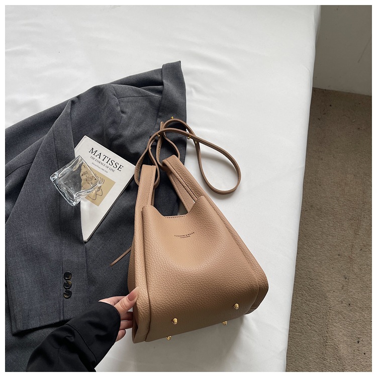 Este año popular simple bolso de cubo portátil para mujeres 2026 nuevo estilo de alto nivel lichi estampado lujoso mochila de hombro