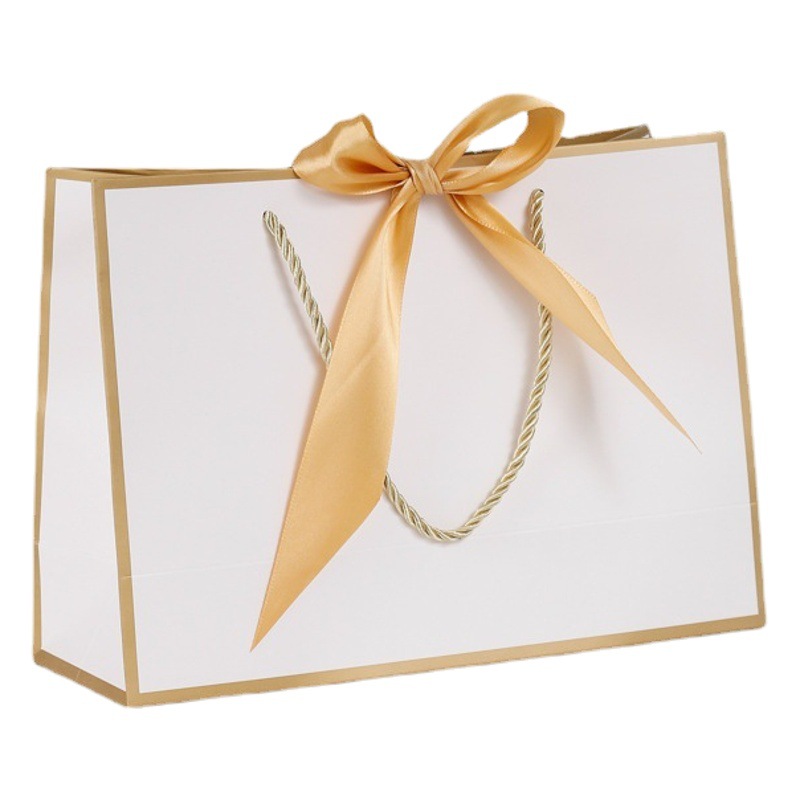 Bolsa de regalo de lazo Bolsa de papel Bolsa de embalaje de ropa Bolsa de cosméticos al por mayor Bolsa de compras Bolsa de mano con logotipo impreso