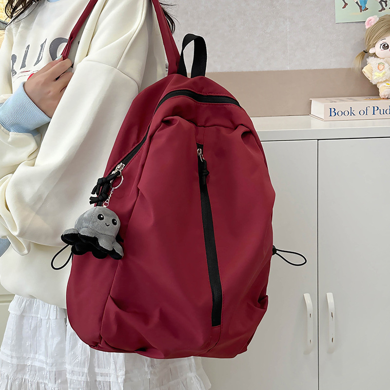 Mochila de viaje ligera al aire libre mochila de montaña de ocio simple de color sólido mochila de estudiantes de secundaria y secundaria gran capacidad