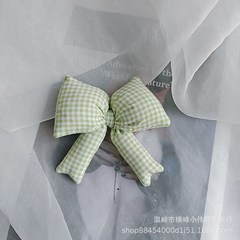 綿の布芸は綿の格子の蝶結びの髪飾りを充填します。