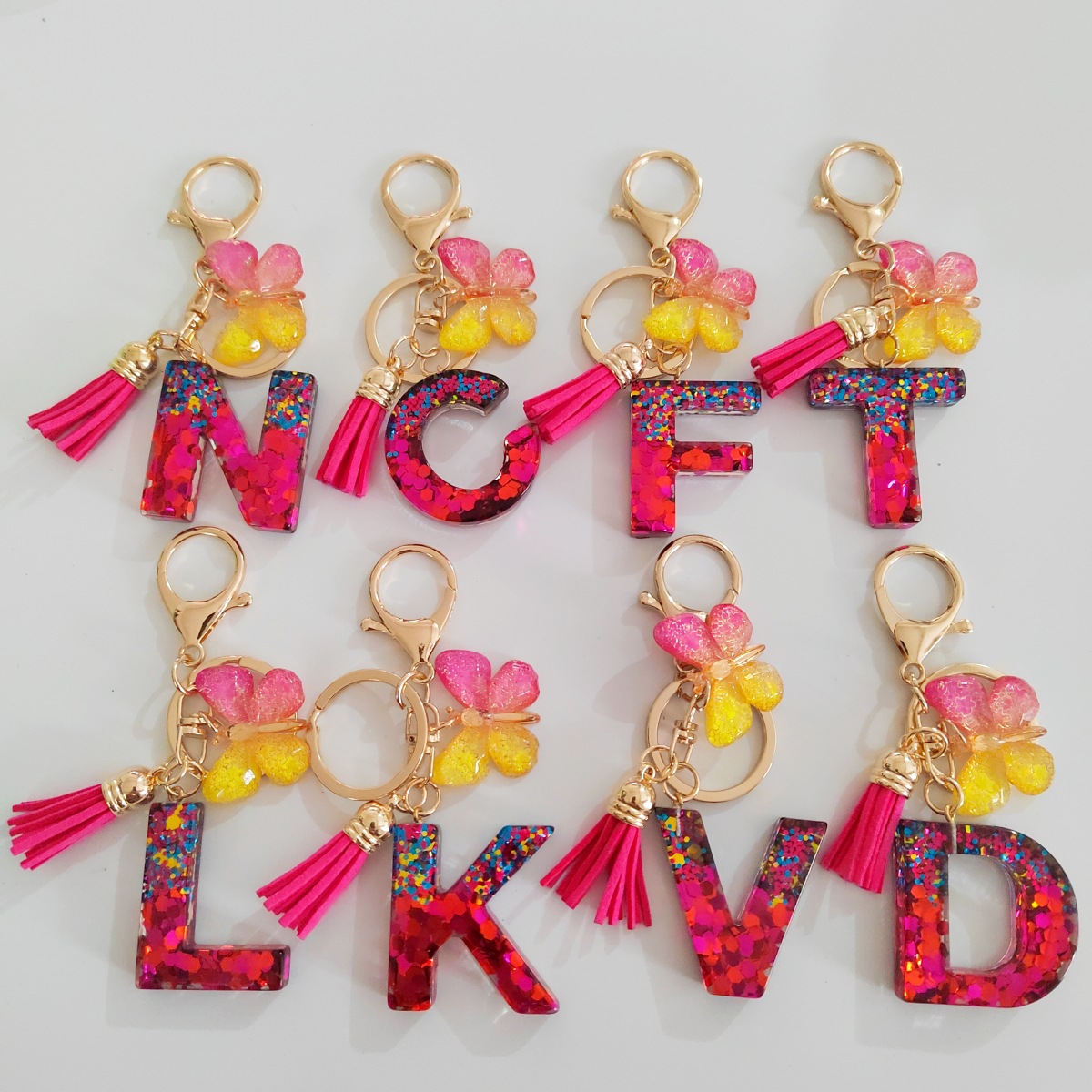 Ventas transfronterizas calientes de letras inglesas de color mixto colgante de llavero colgante de mariposa fringe de resina de llavero colgante de joyería