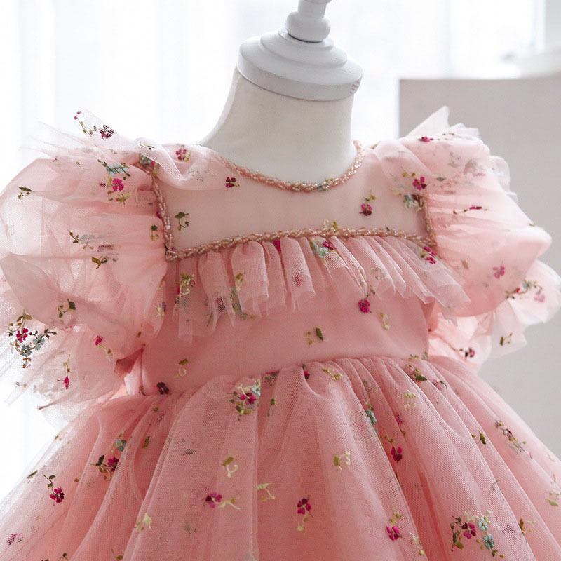 One-year-old pink dress baby's first bir...