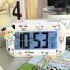 White alarm clock, ice-cream Pacha dog, battery, stickers