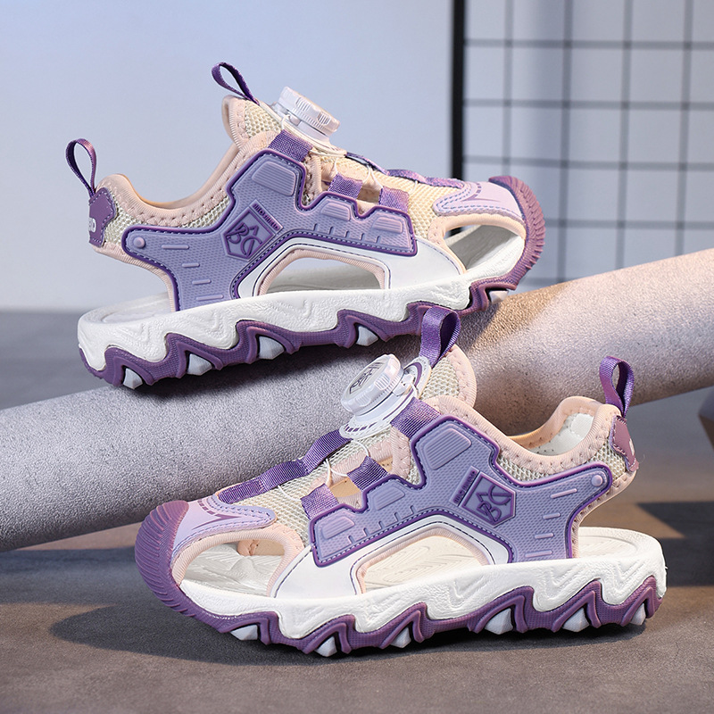 Verano 2025 nuevo estilo sandalias de malla hueca para niños zapatos de playa Baotou botones giratorio sandalias deportivas para niños de suela suave