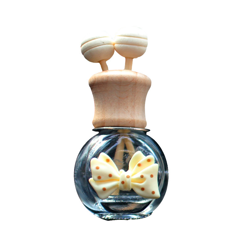 Salida de aire de perfume de coche, dibujos animados, celebridad de Internet, botella de aromaterapia de coche, clip de aire acondicionado, accesorios de coche, bowknot tembloroso