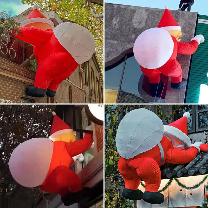 空気入れサンタクロースの空気型は壁に登って光るクリスマスツリーを飾って雪だるまの屋外のデパートの漫画の空気型を飾ってカスタマイズします。|undefined