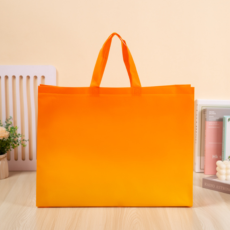 En stock bolso no tejido logotipo promocional película grande tienda de ropa bolsa de compras publicidad engrosada bolso de compras