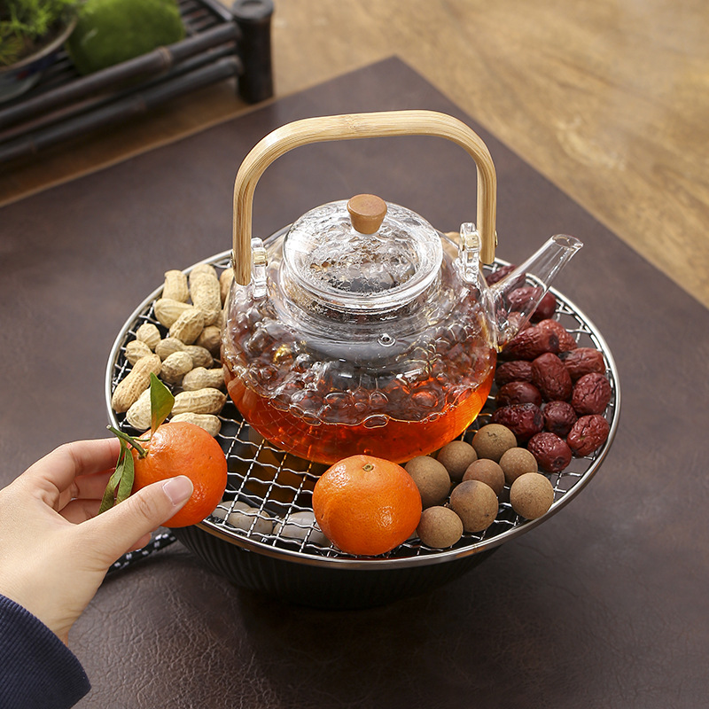 ネットの赤い囲炉裏はお茶を煮ます室内の家庭用のセットの電気陶炉のお茶のセットのガラスのティーポットを煮ます。