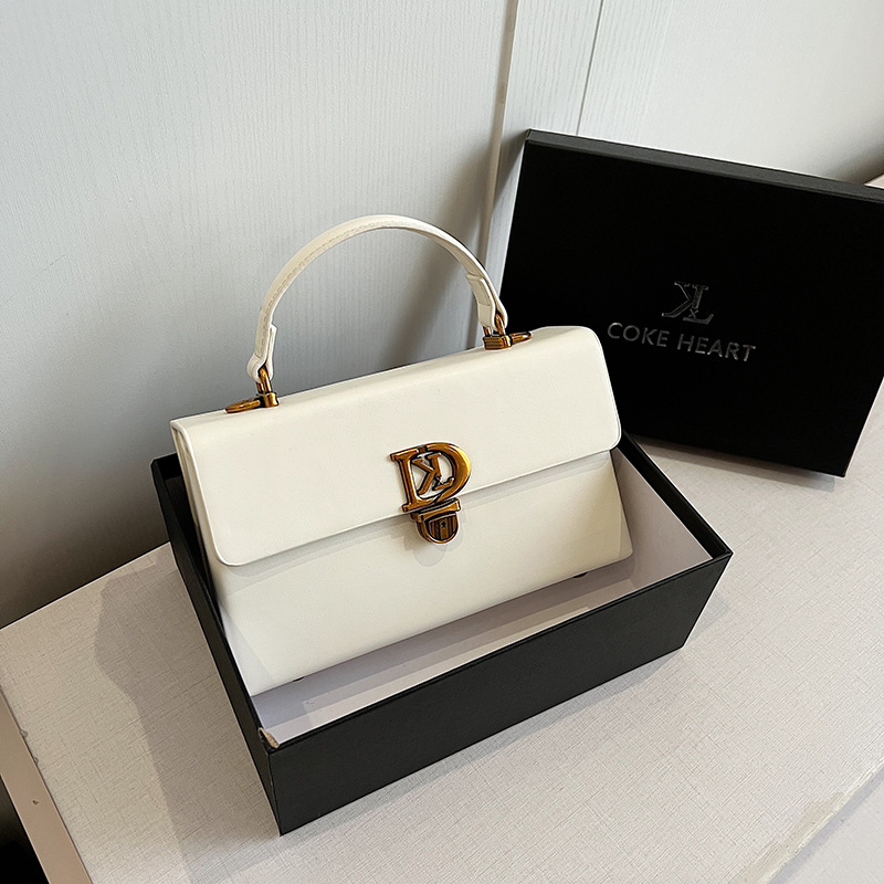 Bolso de diseño de nicho de sentido de alta gama para mujer 2025 nuevo bolso de mensajero de un solo hombro de moda con cerradura de mano bolso cuadrado pequeño