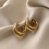Golden overlapping circular earrings