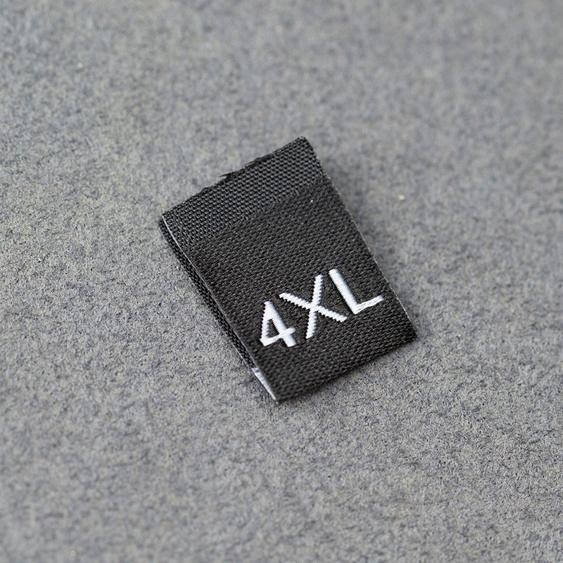 En stock Etiqueta de tamaño de alta densidad en blanco y negro Etiqueta de tamaño universal Etiqueta de código de letra inglesa Pantalones Etiqueta de código de cuello de camiseta