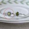 Silver olive green twist round ring