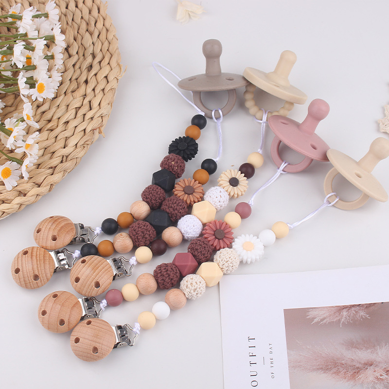 Productos para bebés Clip de chupete de haya Dibujos animados de bebé creativo pequeña margarita pequeña mordedor molar cadena de chupete anti-caída
