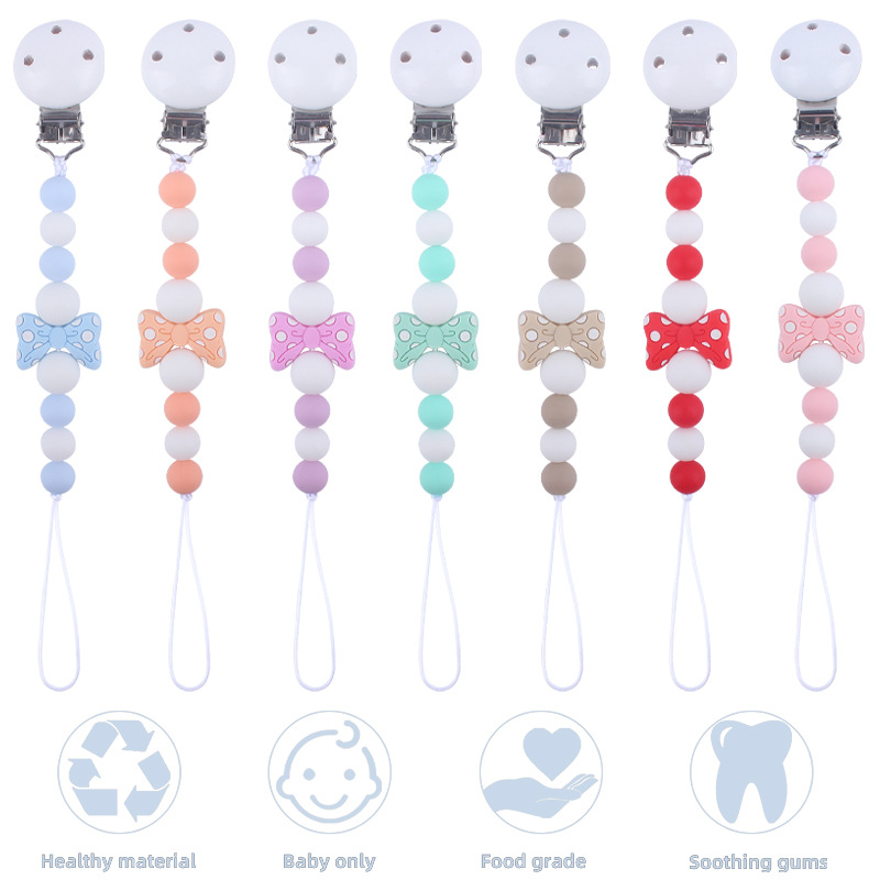 Suministros para bebés hemu clip de chupete calmante bebé de dibujos animados arco mordedura pegamento cadena de chupete cadena anti-caída nueva