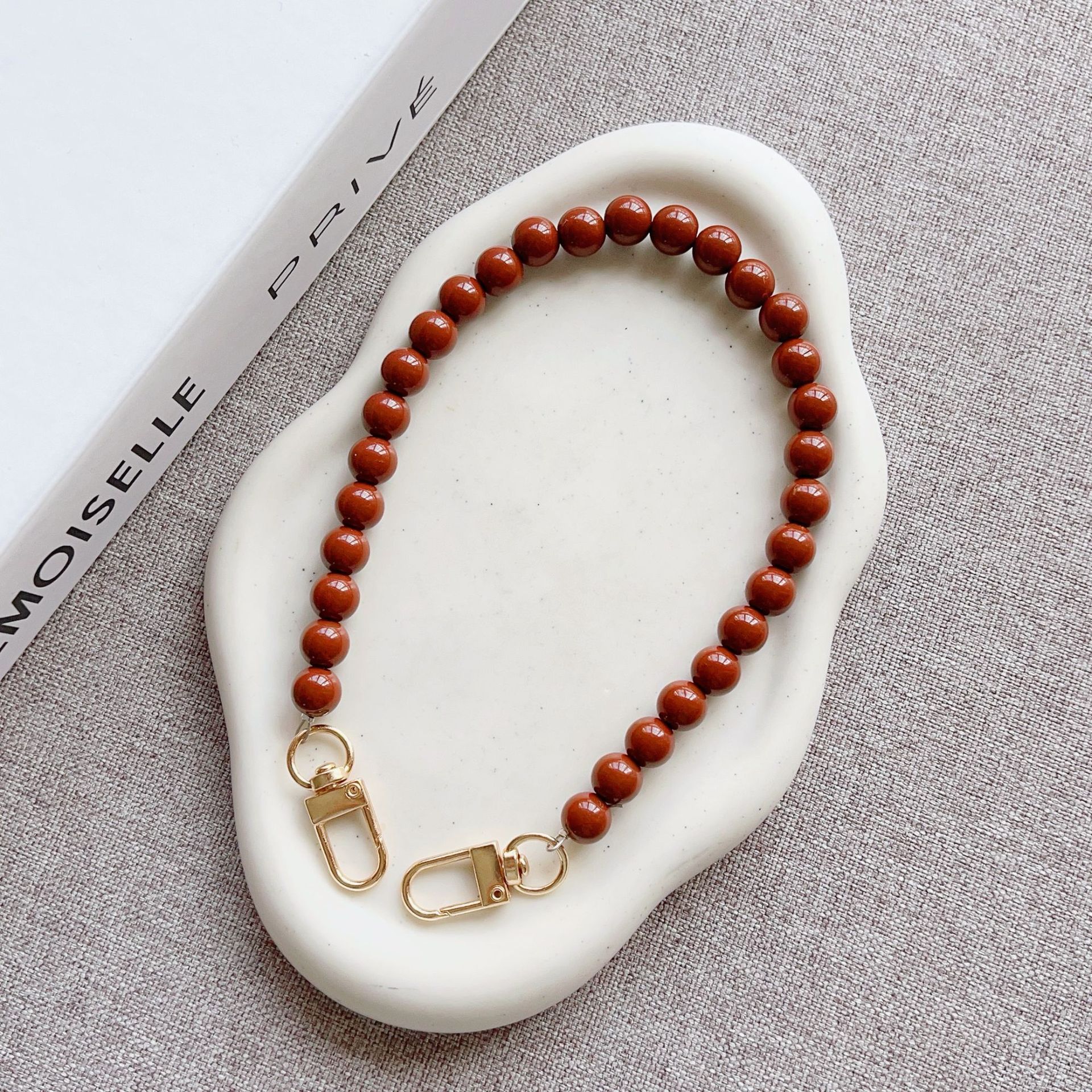 Nuevo estilo japonés y coreano cadena de cuentas de color sólido pulsera corta llavero bolsa de accesorios de cadena de perlas de todo fósforo cordón transfronterizo