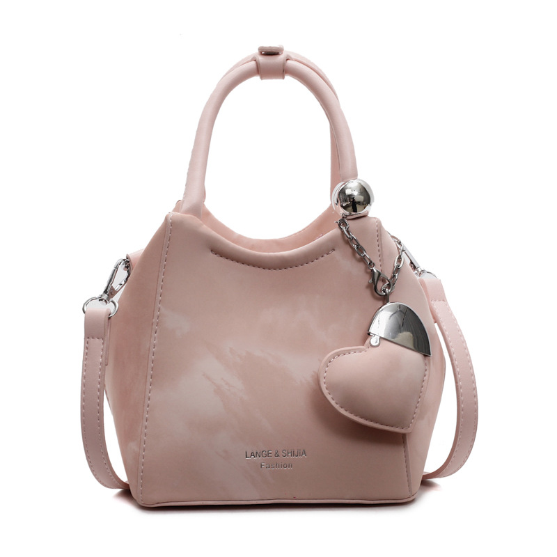 Nicho de diseño de bolsas de cubo de mano para mujeres 2025 nuevo estilo coreano bolso de hombro universal de moda retro bolso de mochila