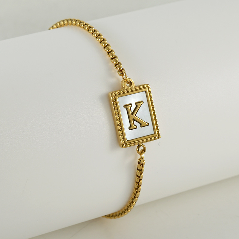 Nuevo europeo y americano transfronterizo de acero inoxidable 26 letras inglesas Shell pulsera personalidad todo partido titanio acero 18K cremallera