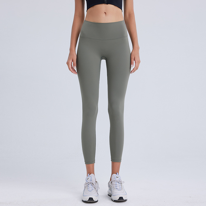 気まずい線の9分のズボンの高弾力のヨガのズボンのレギンスの女性の美のヒップのズボンのやせている腰はやせている運動のタイツを現します