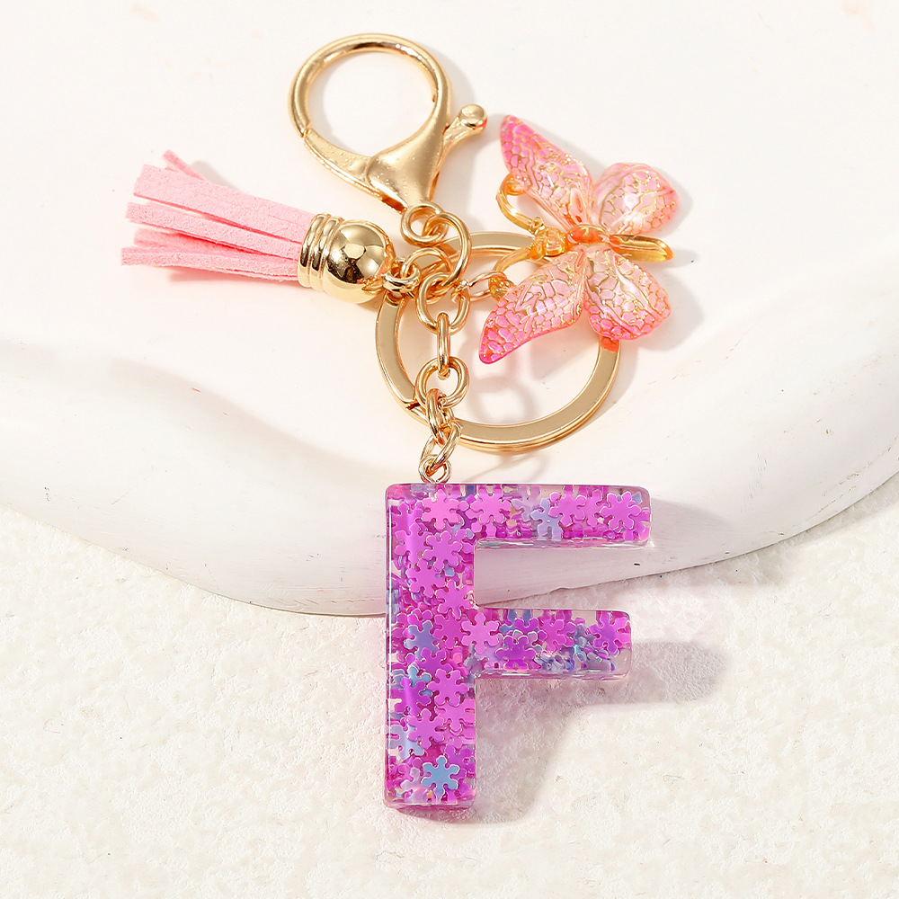 Nuevo color púrpura claro mezcla de polvo brillante letras inglesas resina llave colgante estilo simple mariposa borda colgante