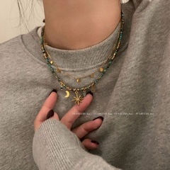 レトロなビーズの重ね付けのネックレスの女性のボヘミアンの太陽の花の小さい大衆は鎖の鎖の首の鎖のセーターの鎖を設計して飾ります。