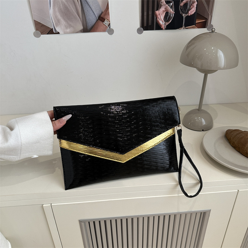 Bolso de sobres de mano de tendencia transfronteriza 2025 primavera nuevo estilo coreano personalidad moda casual temperamento color de contraste bolso de banquete