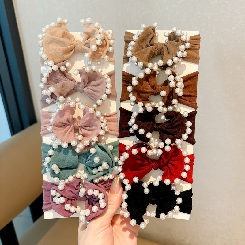 Arco de perla máscara anillo de cabello femenina baja cuerda de cabello bola adornamiento de cabello correa de cuero cuerda de cabello al por mayor