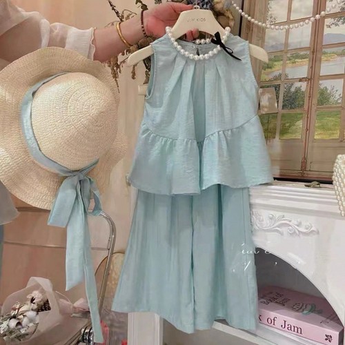 Stylish sleeveless girls' summer set: toddler and small child ruffled blouse with wide-leg pants, trendy two-piece outfit