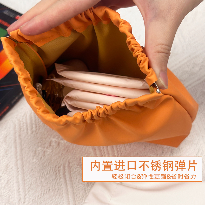 Nuevo impermeable pu bolsa de cosméticos lápiz labial de las mujeres sanitaria servilleta metralla bolsa de almacenamiento portátil cable de datos auriculares bolsa de almacenamiento