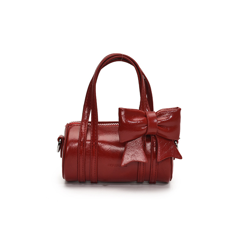 Bolso cilíndrico para niña de color sólido simple bolso de bebé con lazo dulce y lindo 2025 moda mini bolso para niños