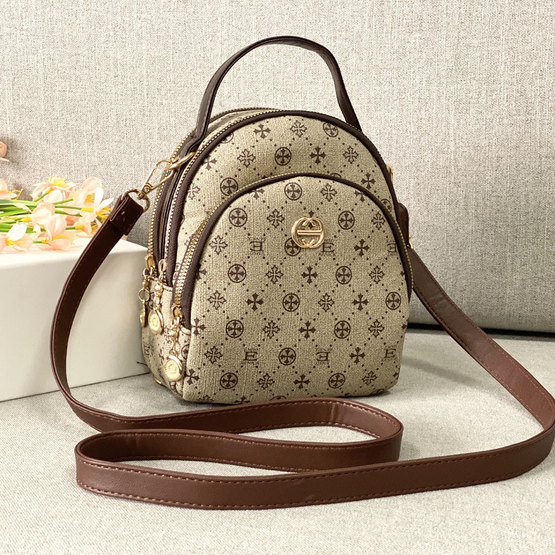 Guangzhou Hengli 2024 nueva moda mochila pequeña bolso de mano bolso de teléfono móvil madre de mediana edad bolso de mensajero de tres usar