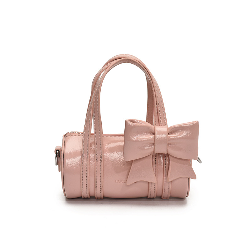 Bolso cilíndrico para niña de color sólido simple bolso de bebé con lazo dulce y lindo 2025 moda mini bolso para niños