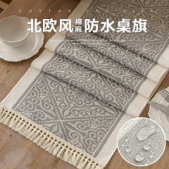 新型の北欧風は綿麻のお茶の旗の布をまねて軽くて豪華な防水のジャカードの長い布のフリンジの食卓のテーブルの旗の代行を代行します。