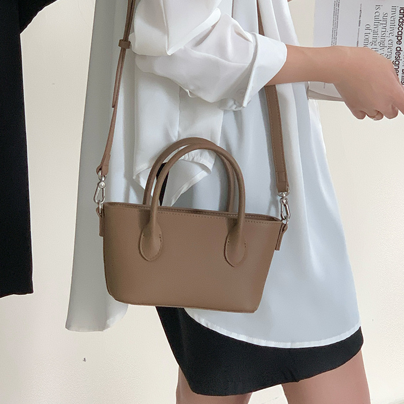 Mini bolsa de cesta de verduras de cuero minimalista 2025 nuevo estilo de piel de vaca Xiaozhong lingote bolso de mensajero portátil bolso de hombro femenino