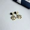 Checked triangle ear clip