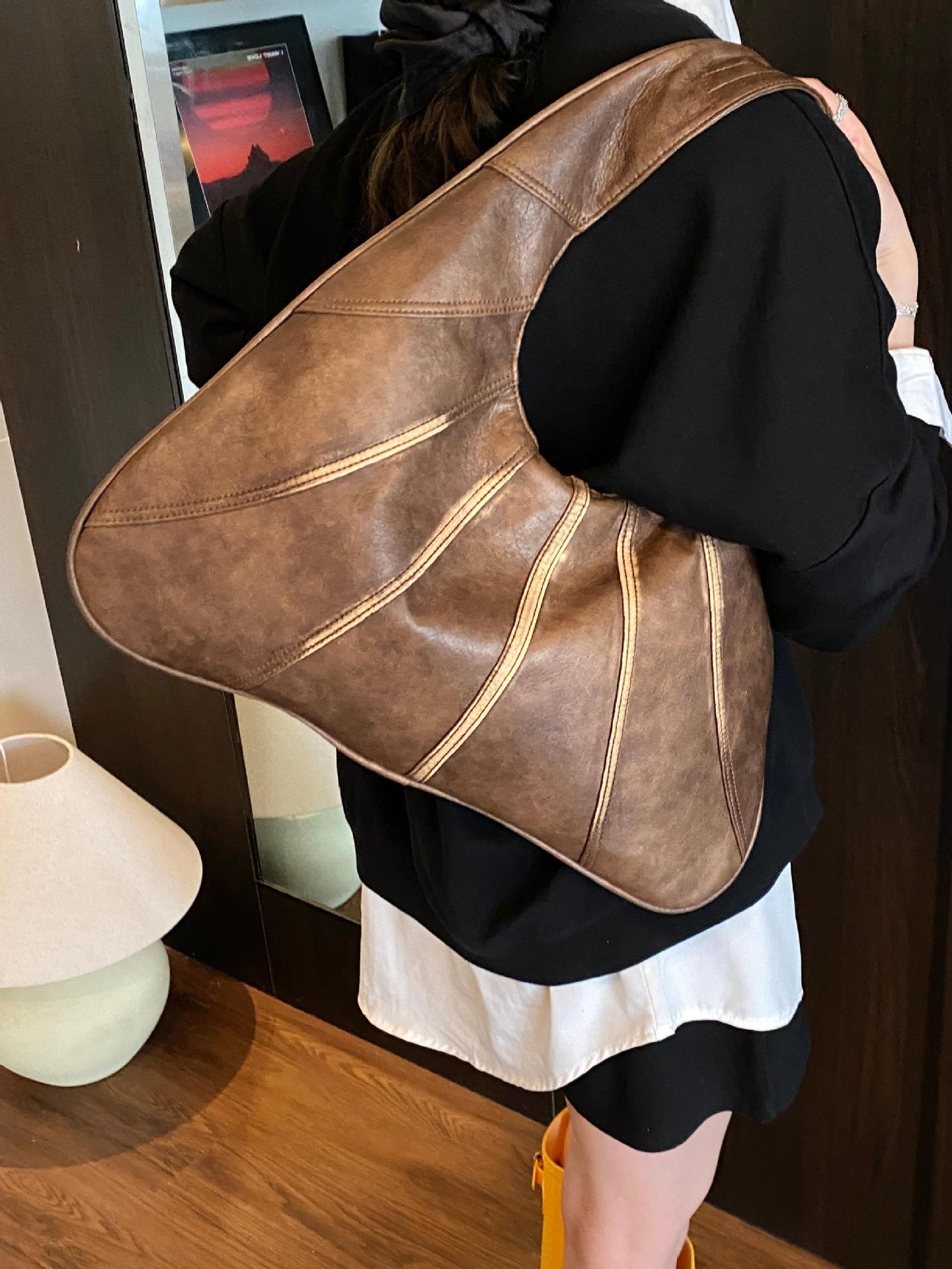 Bolsos retro para axilas para mujer 2025 nuevo bolso de hombro de nicho casual de todo fósforo bolso de viaje portátil de alta gama de moda