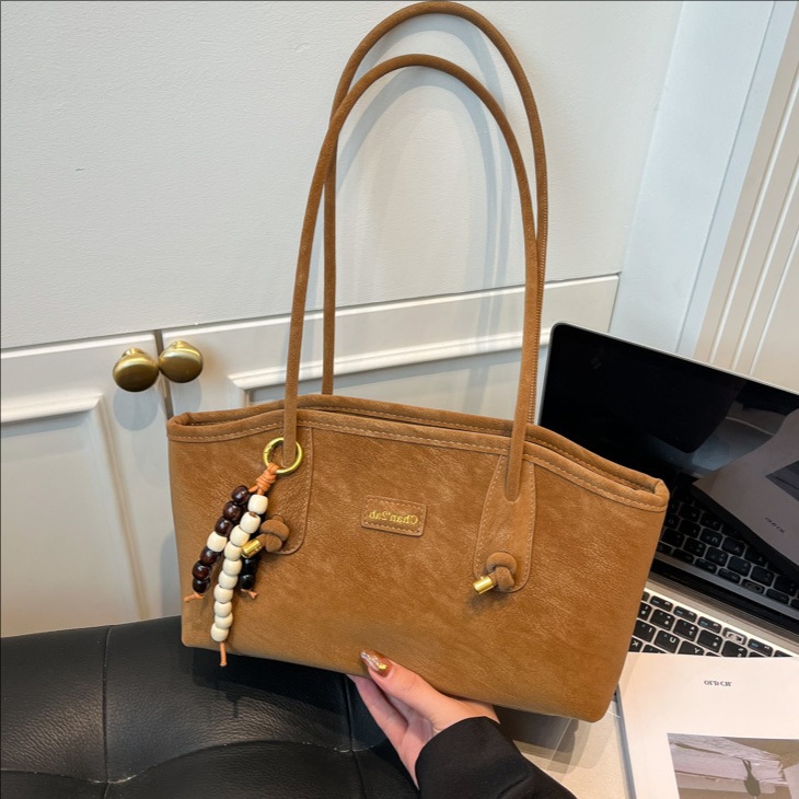 Bolsa de hombro casual coreana de nicho retro simple bolsa de brazo de viaje para mujeres 2025 nueva moda bolsa de mano