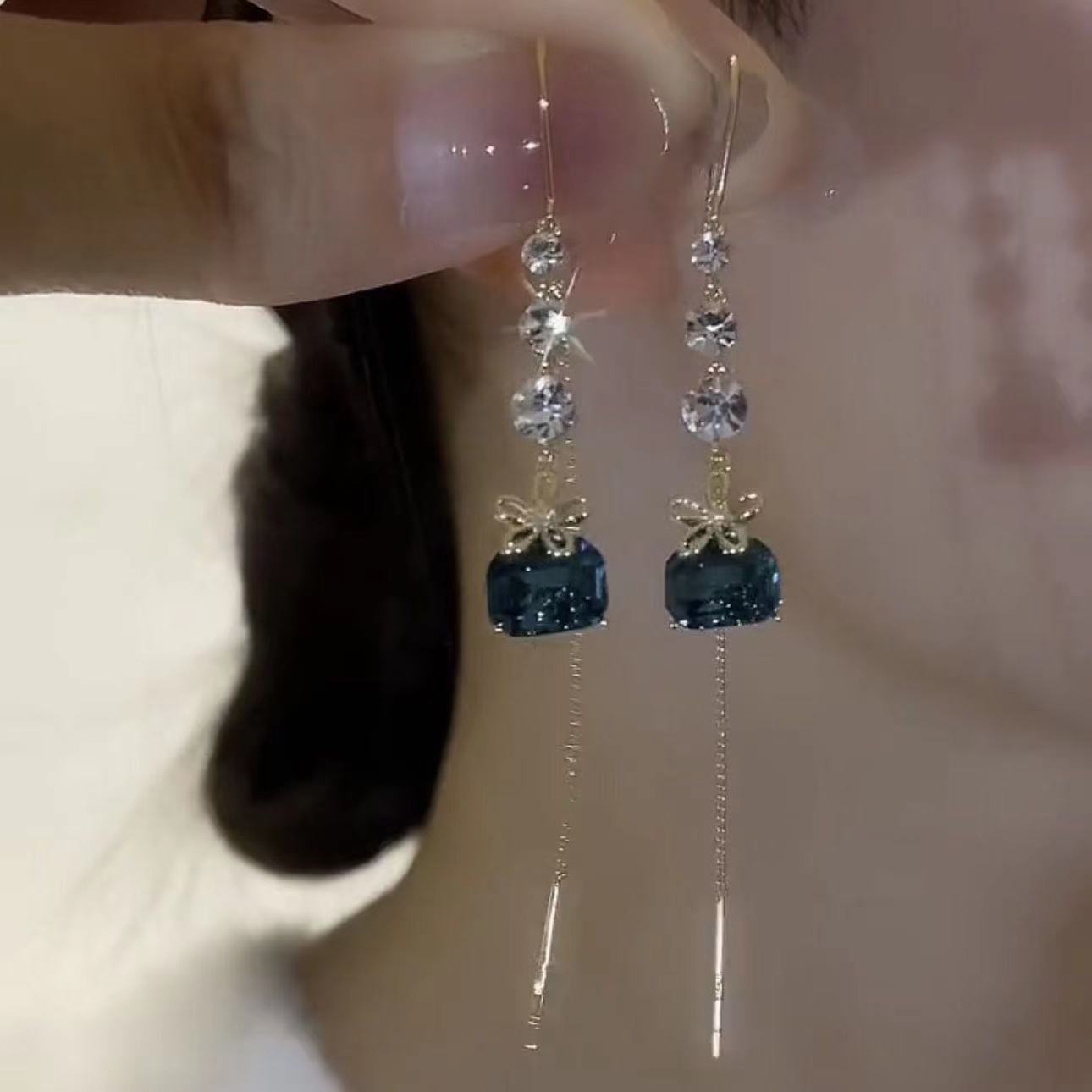 blue sophisticated small design fashionable earrings with tassels…