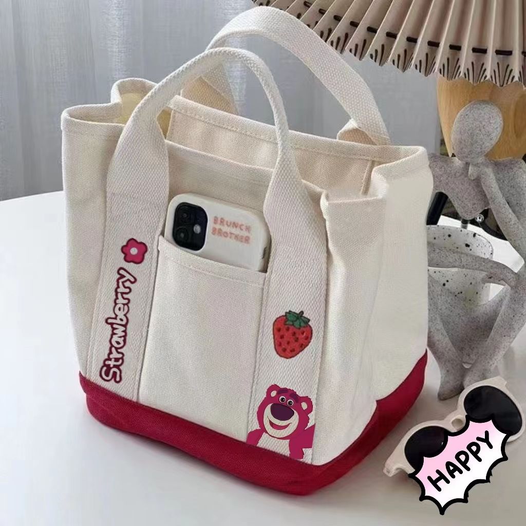 A small handbag is carried by a female student going out. She is carrying a 2024 new style bag, a mini canvas bag, and a Korean version bento bag for female students full figure