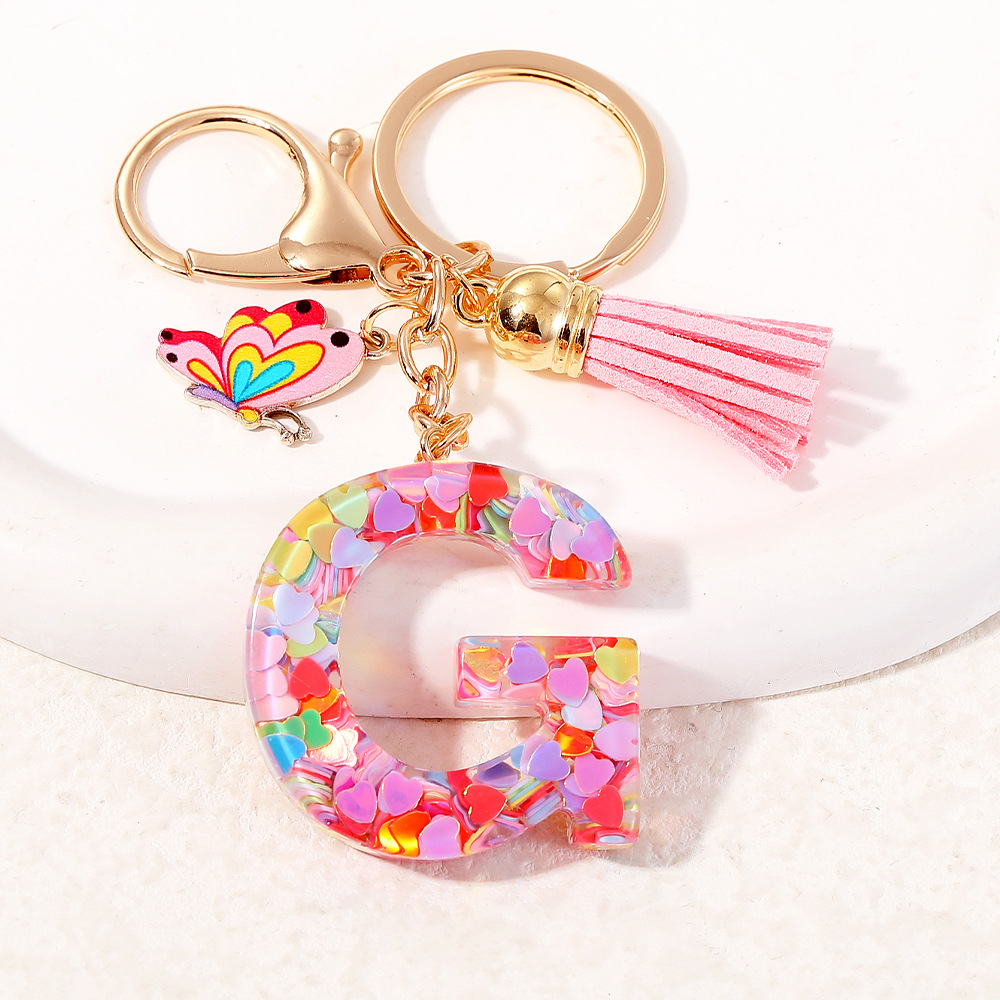 2024 puntos transfronterizos de resina de sequilla rosa 26 letras inglesas llavero colgante mariposa fringe accesorios