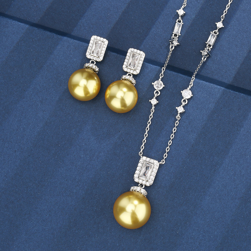 Otoño e invierno nuevo estilo Zhuang Shengsheng joyería fondo de cobre chapado en oro con incrustaciones de perlas de oro profundo borla traje premium femenino 16-14m