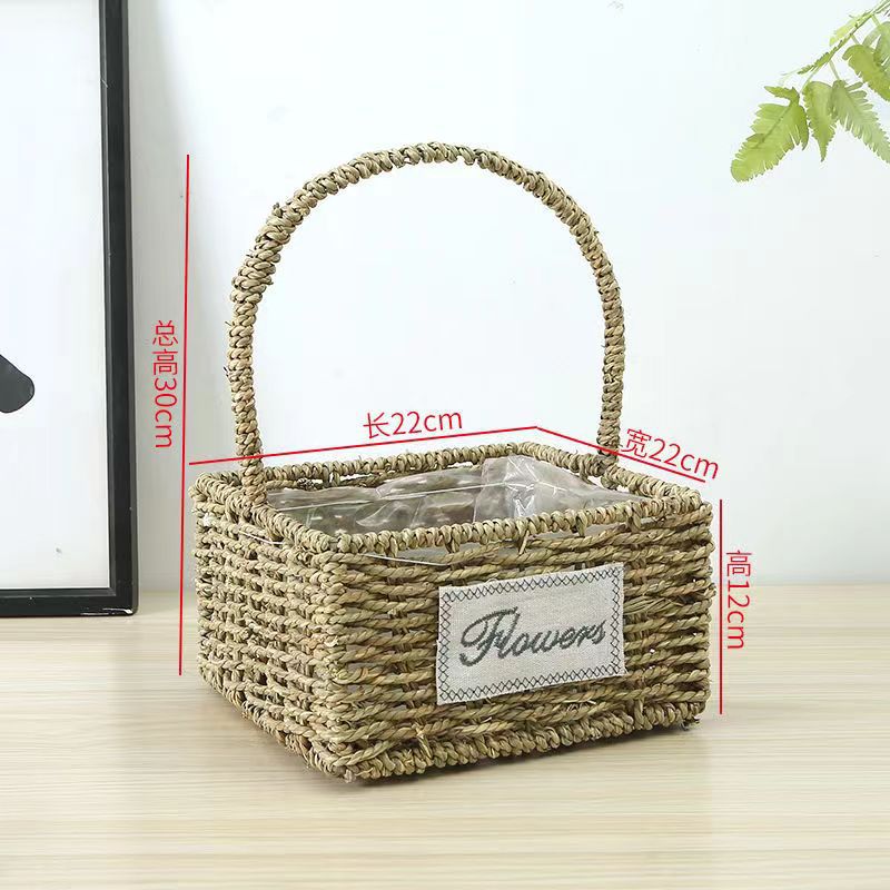 Fabricantes de cestas de flores ovales rectas de paja hechas a mano en stock al por mayor cestas de flores de paja portátiles decoración de viento pastoral